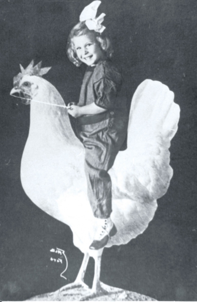 Girl riding a chicken statue